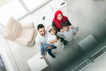 Happy Muslim family at modern home having fun and good time togetherの写真素材