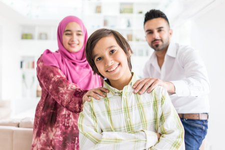 Happy Arabic Muslim family at modern home having fun and good time togetherの写真素材