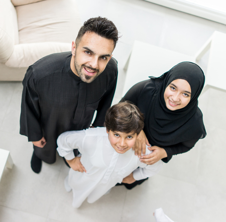 High angle view portrait of happy Arabic Muslim family at new modern homeの写真素材