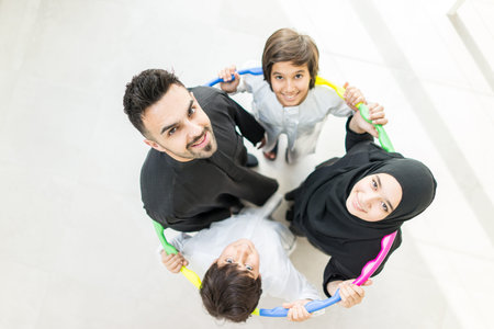 Happy Arabic Muslim family at modern home having fun and good time togetherの写真素材