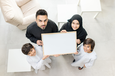 High angle view portrait of happy Arabic Muslim family at new modern homeの写真素材
