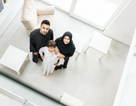 High angle view portrait of happy Arabic Muslim family at new modern homeの写真素材