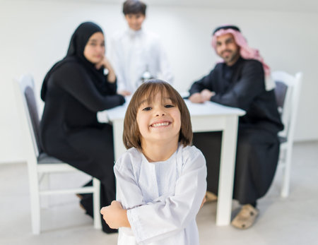 Happy Arabic family at dining roomの写真素材