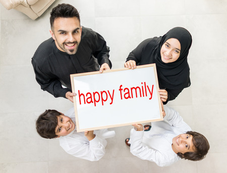 High angle view portrait of happy Arabic Muslim family at new modern homeの写真素材
