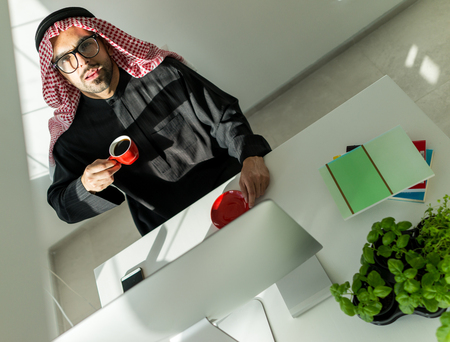 Arabian Gulf young businessman at office working on computerの写真素材