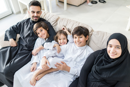 Happy Arabic Muslim family at modern home having fun and good time togetherの写真素材
