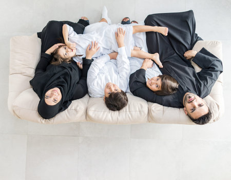 Happy Muslim family at modern home having fun and good time togetherの写真素材