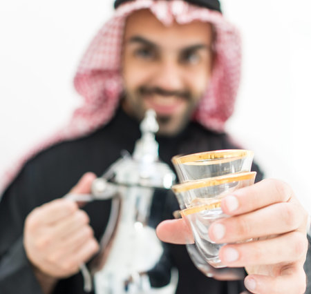 Gulf Arabian young man with traditional welcome hospitality coffeeの写真素材