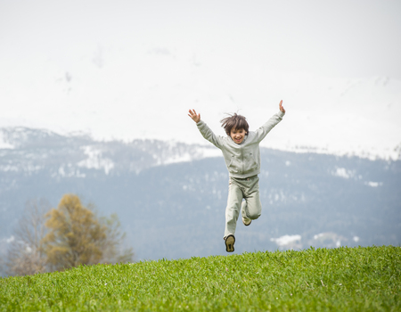 Child on beautiful mountain fieldの写真素材