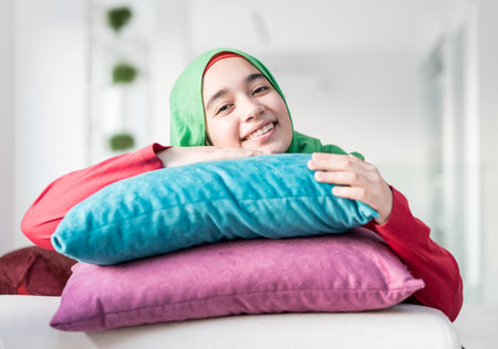 Muslim girl with pillow at homeの写真素材