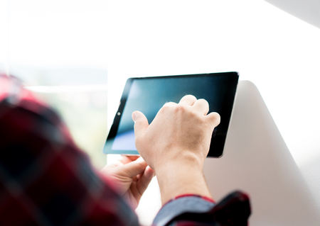 Man working on smart home deviceの写真素材