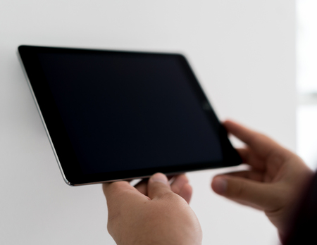Man working on smart home deviceの写真素材