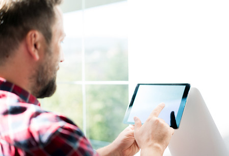 Man working on smart home deviceの写真素材