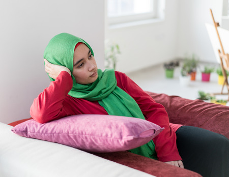 Muslim girl with pillow at homeの写真素材
