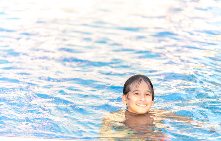 Children enjoying in summer resort at pool