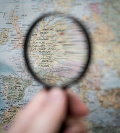 Searching map with magnifierの写真素材