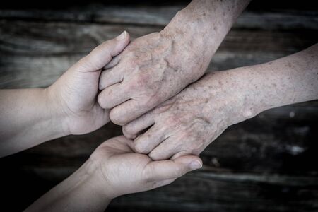 Young and old hands love and careの写真素材