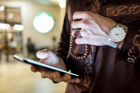 Gulf man with smart phone in hand closeup