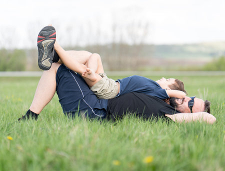 Father and son on grass