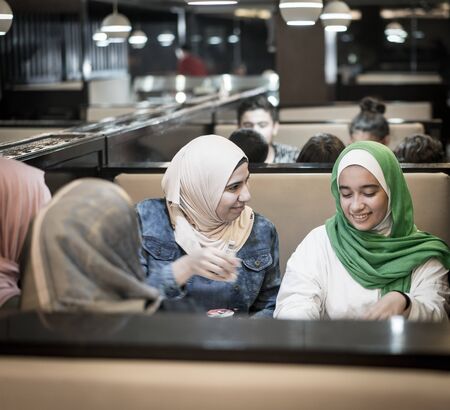 Muslim girls at restaurant having iftarの写真素材