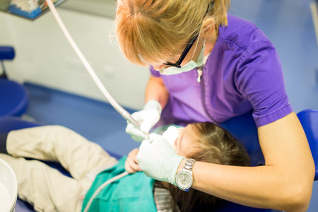 Young Smiling Boy Posing Before Regular Dental Check Up in Clinic