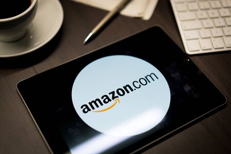 New York, New York / USA - 11 11 2019: Logo of Amazon on the iPad Air2 in on office deskのeditorial素材