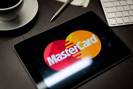 New York, New York / USA - 11 11 2019: Logo of MasterCard on the iPad Air2 in on office deskのeditorial素材