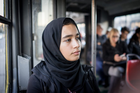 Middle Eastern girl riding public transport in city