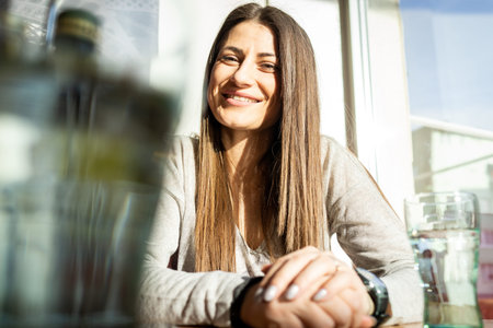 Young woman eating food in a restaurant, having lunch break