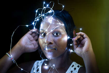 Beautiful African American girl with blurred lightsの写真素材