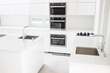 White organised kitchen with modern elements in an apartment . High quality photoの写真素材