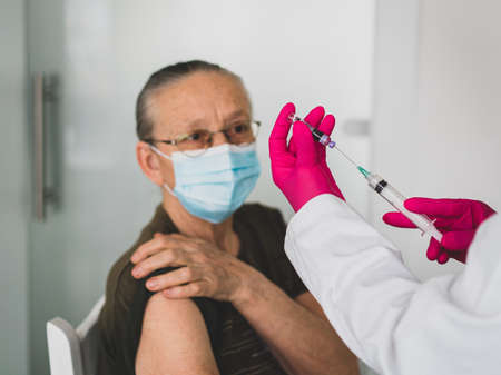 Senior old woman in hospital getting vaccine 2021の写真素材