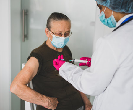 Senior old woman in hospital getting vaccine 2021の写真素材