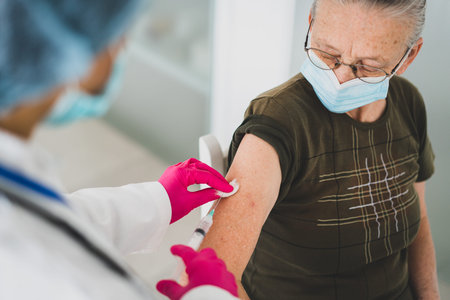 Senior old woman in hospital getting vaccine 2021