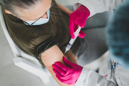 Senior old woman in hospital getting vaccine 2021の写真素材