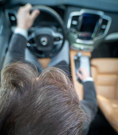 Funny wide angle of a male driver in luxury carの写真素材