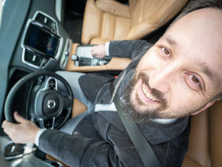 Funny wide angle of a male driver in luxury carの写真素材