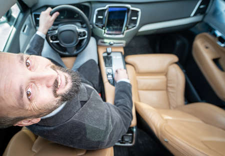 Funny wide angle of a male driver in luxury carの写真素材