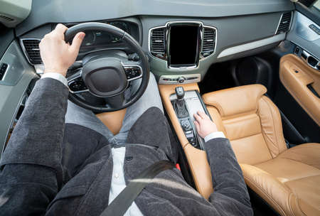 Funny wide angle of a male driver in luxury carの写真素材