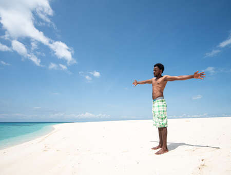 Young black African man on beautiful beach seaの写真素材