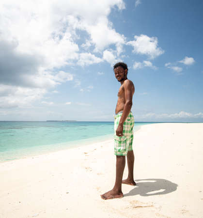 Young black African man on beautiful beach seaの写真素材