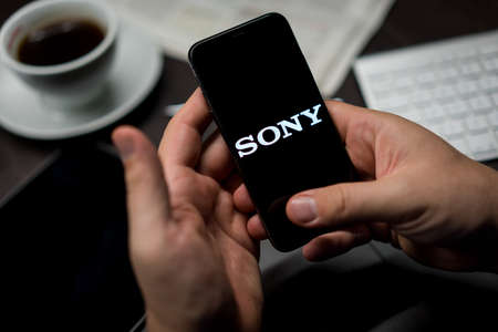 New York, New York / USA - 11 11 2019: Logo of Sony on the iPhone X in hands in officeのeditorial素材
