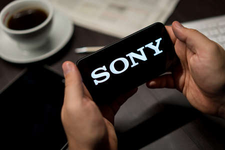 New York, New York / USA - 11 11 2019: Logo of Sony on the iPhone X in hands in officeのeditorial素材