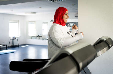 Arabic woman active working out in big gymの写真素材