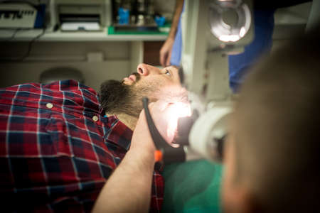 Doctor in hospital checking patient the earの写真素材