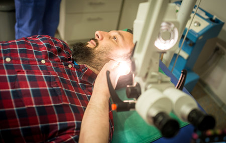 Doctor in hospital checking patient the earの写真素材