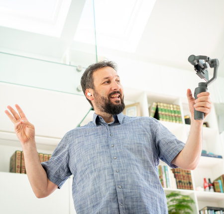 Adult male vlogger streaming online at homeの写真素材