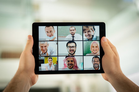 Online business conference screen in hands new normalの写真素材