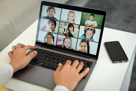 Arabic female teacher working with children online school during pandemicの写真素材