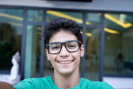 Boy smiling looking into cameraの写真素材